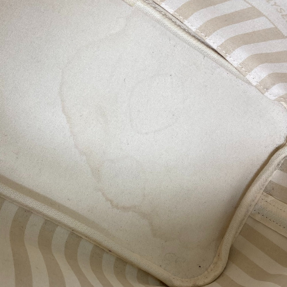Close-up of a textured beige fabric surface with a striped pattern