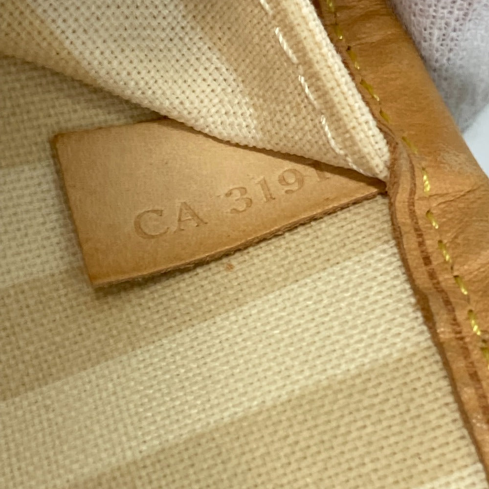 Close-up of a beige fabric with a leather tag displaying 'CA 319'.