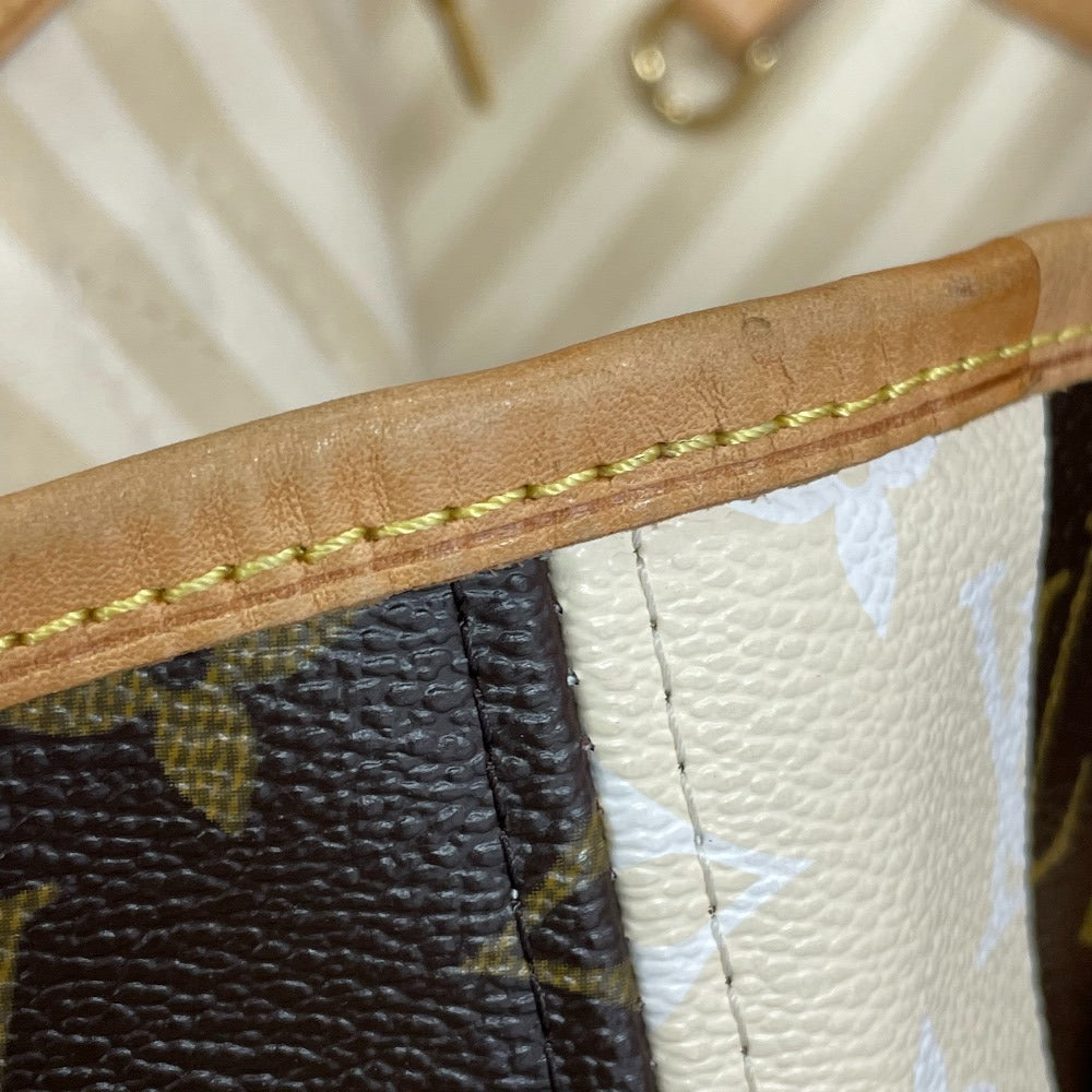 Close-up of a brown leather handle with gold stitching on a Louis Vuitton bag.