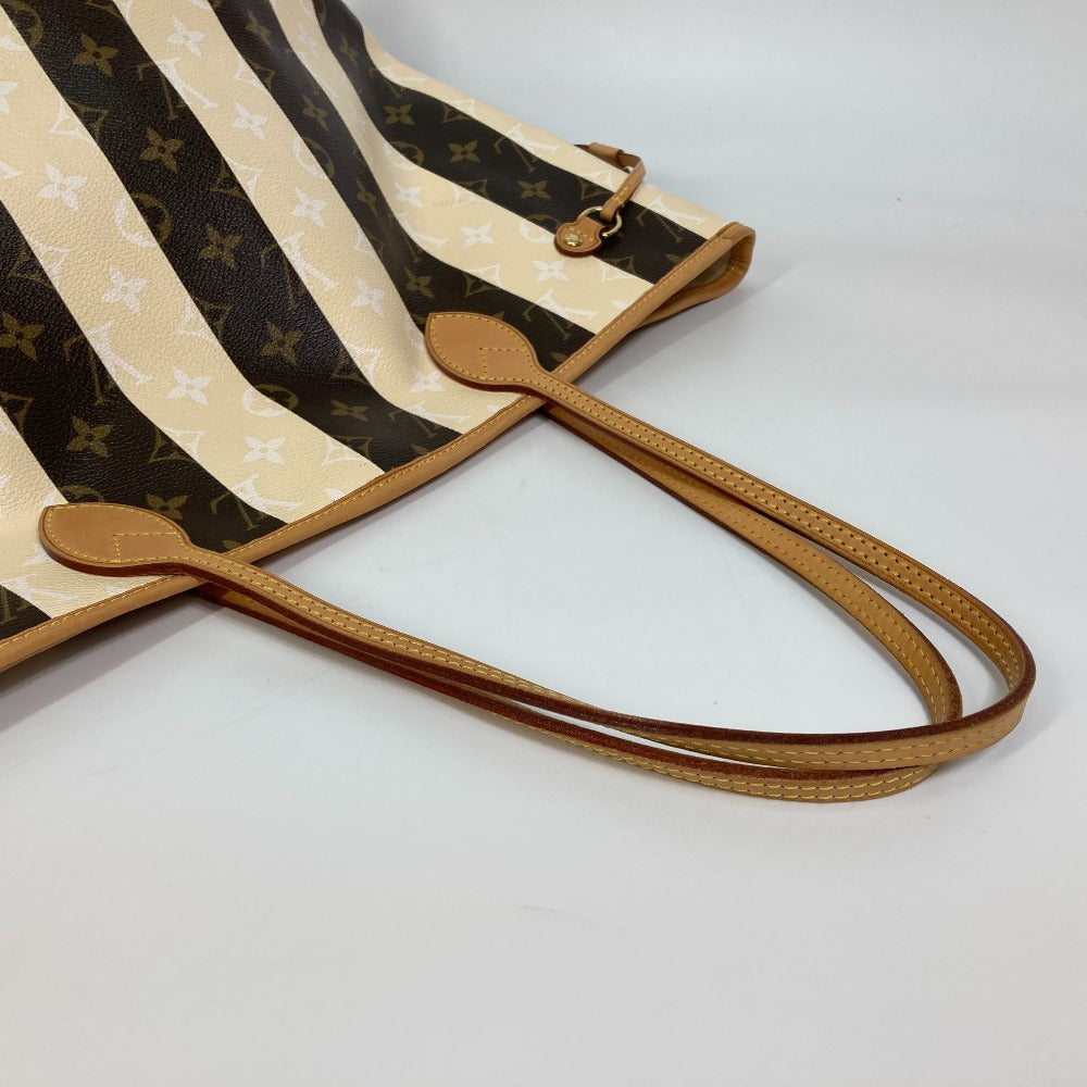 Designer handbag with monogram pattern and brown leather strap on a white background