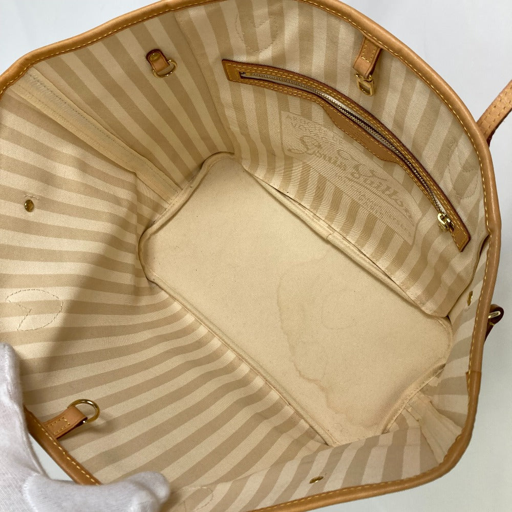 Open handbag with striped interior and visible brand logo on a white background