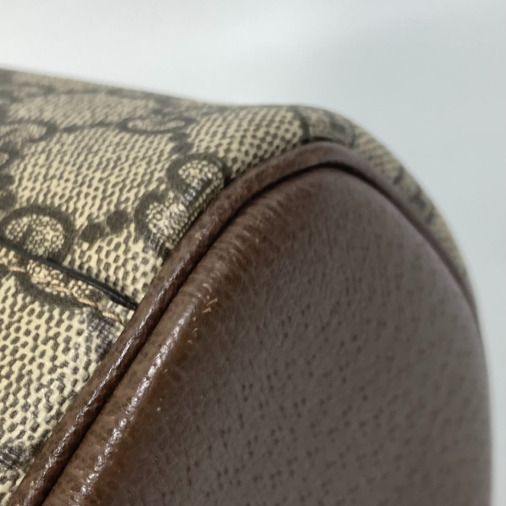 Close-up of a brown leather product with a patterned fabric surface on a white background