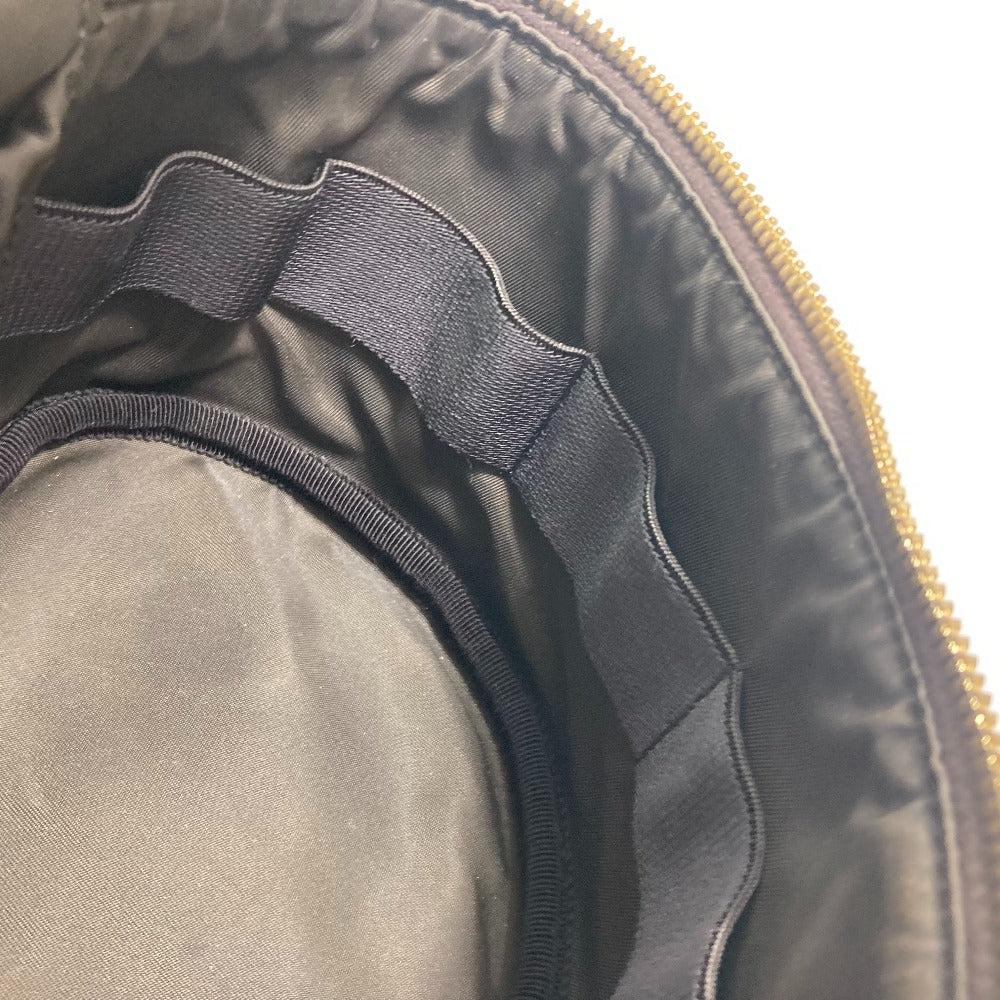 Close-up of a guitar case with a zipper and black interior lining.