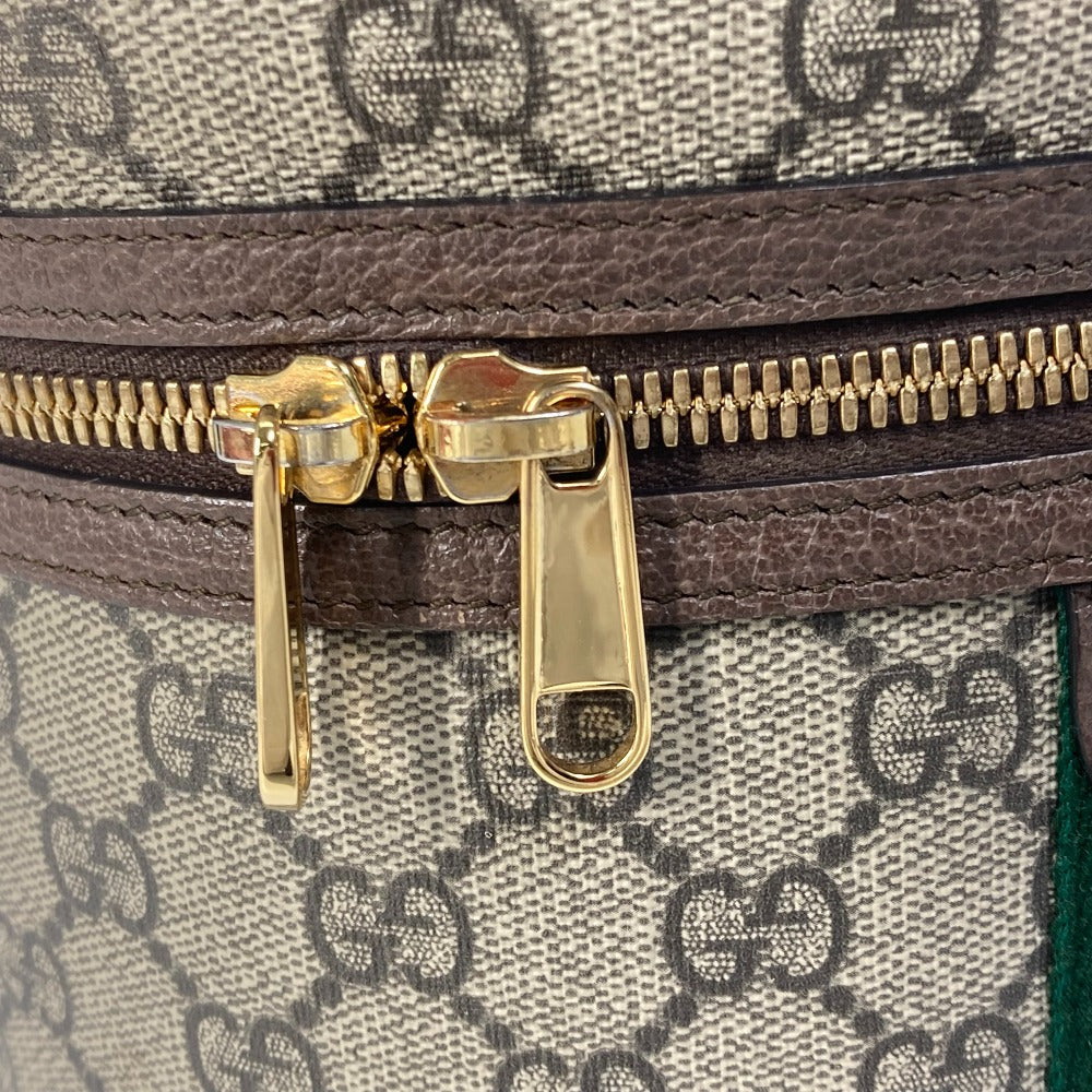 Close-up of a Gucci bag with gold zipper and monogram pattern
