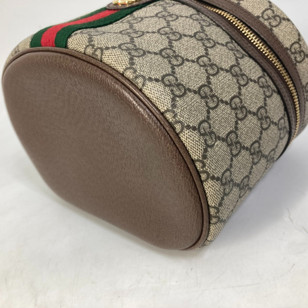 Designer pouch with brown leather accents and patterned fabric on a white background