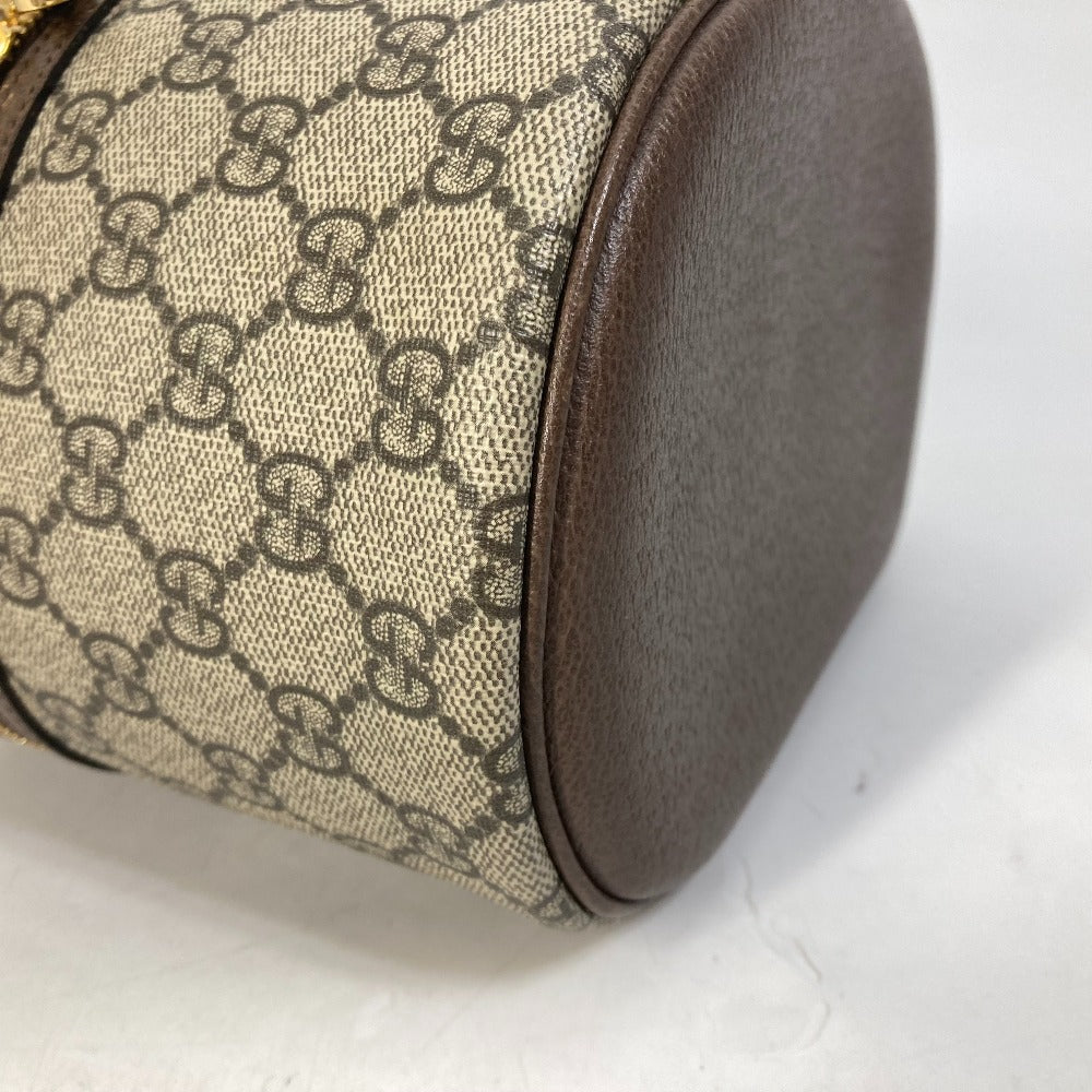 Round pillow with patterned fabric and brown leather trim on a white background