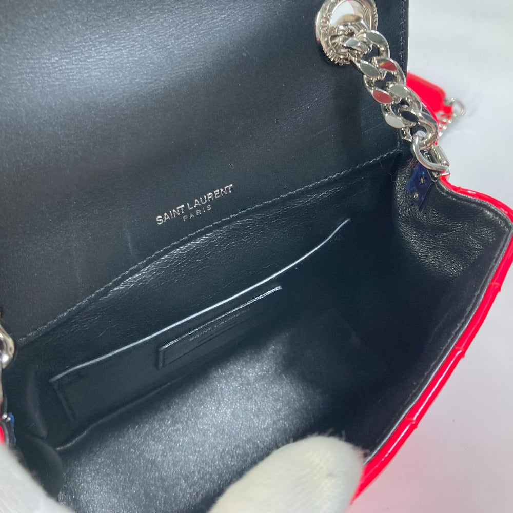 Black handbag with 'Saint Laurent' branding on a light gray background