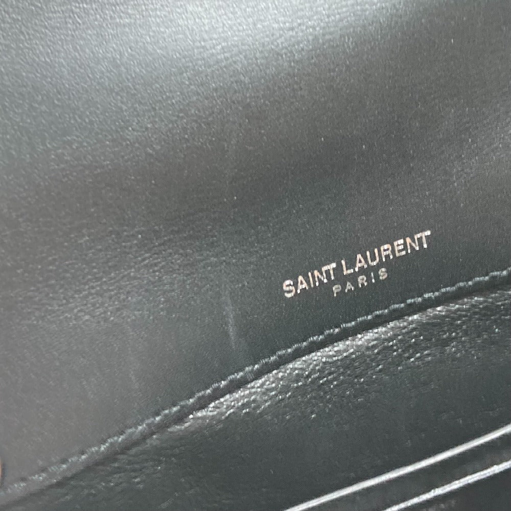 Close-up of a black leather bag with 'Saint Laurent Paris' branding.