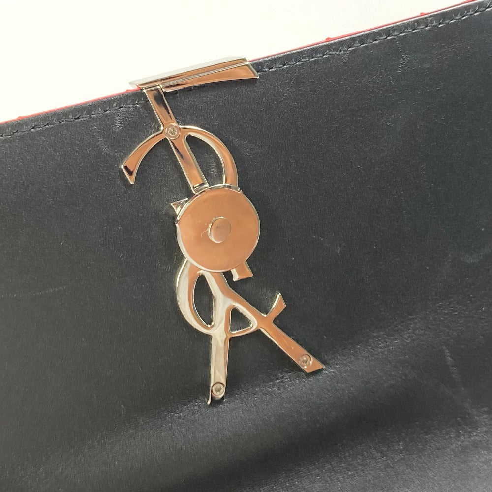 Close-up of a gold logo on a black leather product
