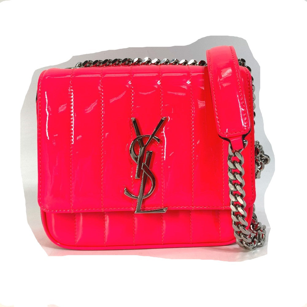 Pink handbag with chain strap on a white background