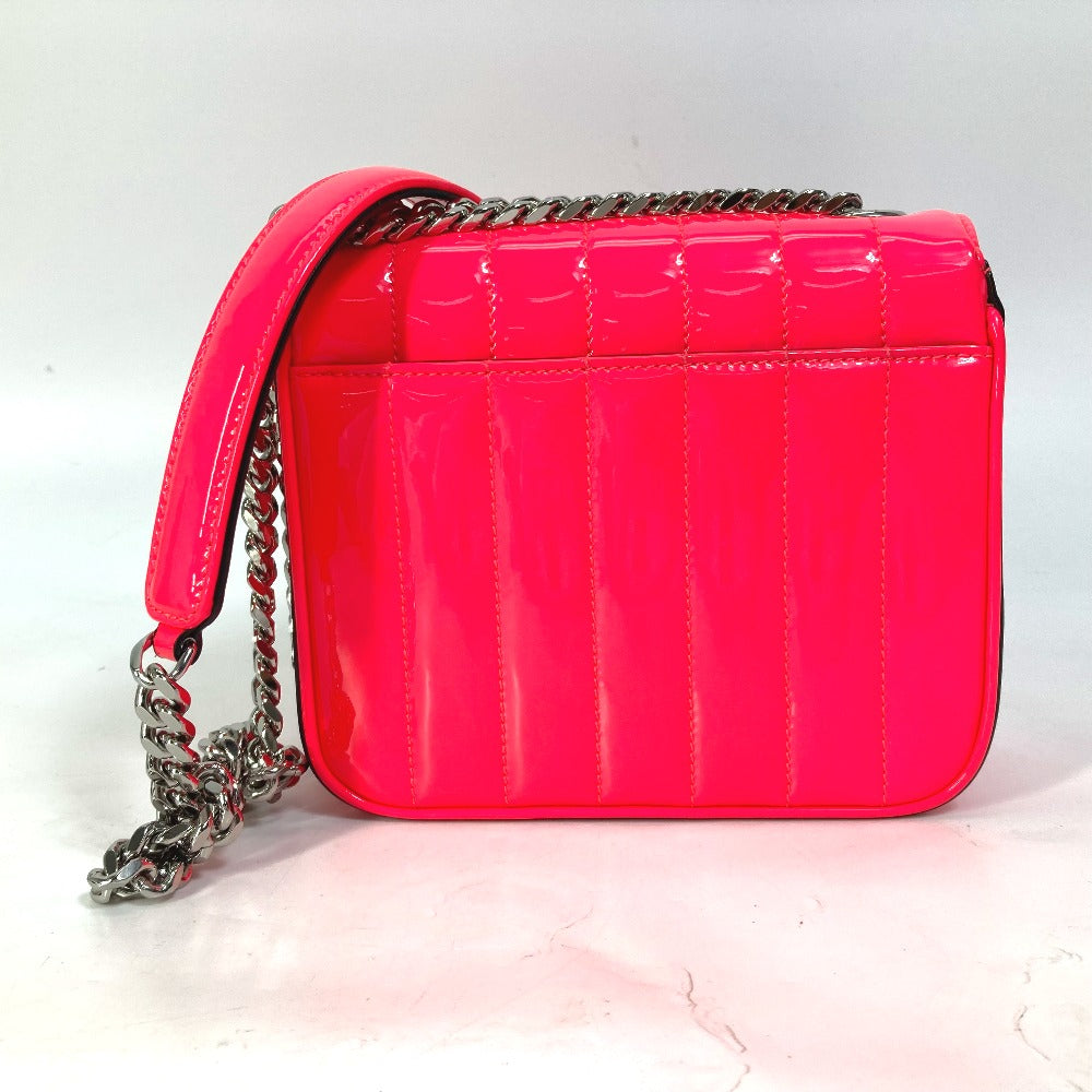 Pink quilted handbag with a chain strap on a light pink background