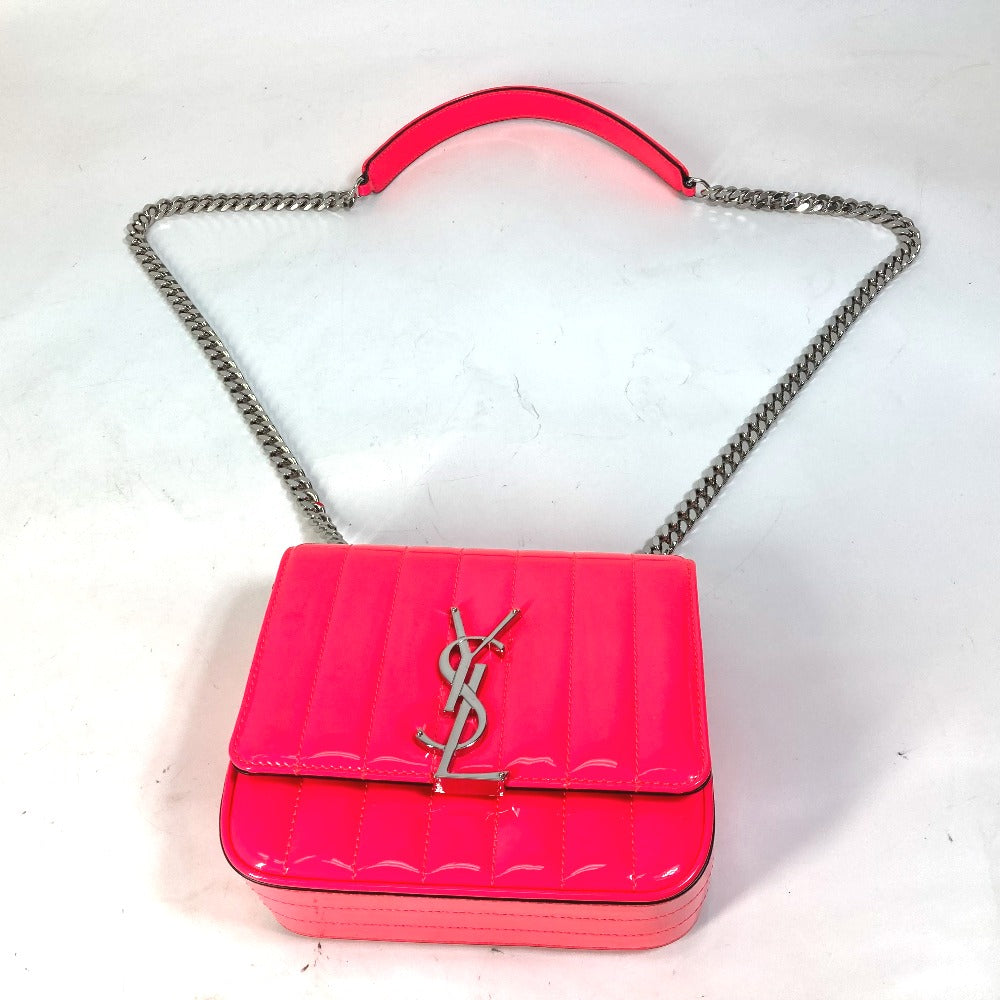 Pink handbag with a chain strap on a white background
