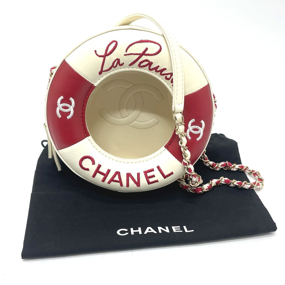 Chanel round bag with red and white design on a black Chanel pouch