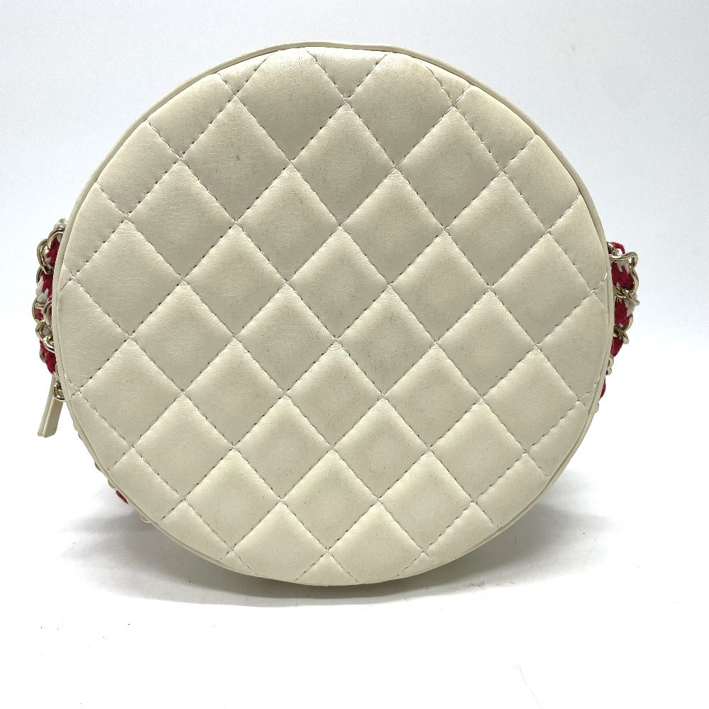 Round quilted beige bag with red accents on a white background