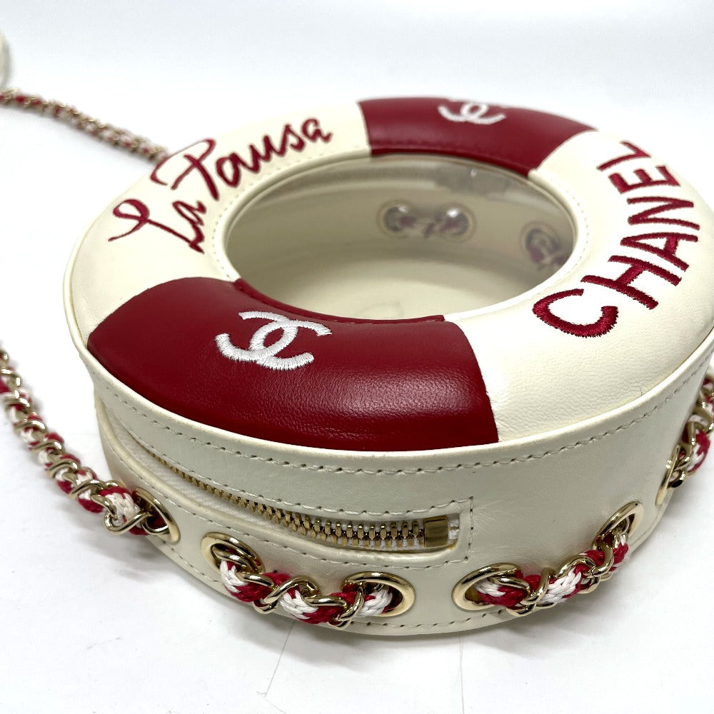 Round handbag with red and white design, featuring 'Chanel' branding, on a white background.