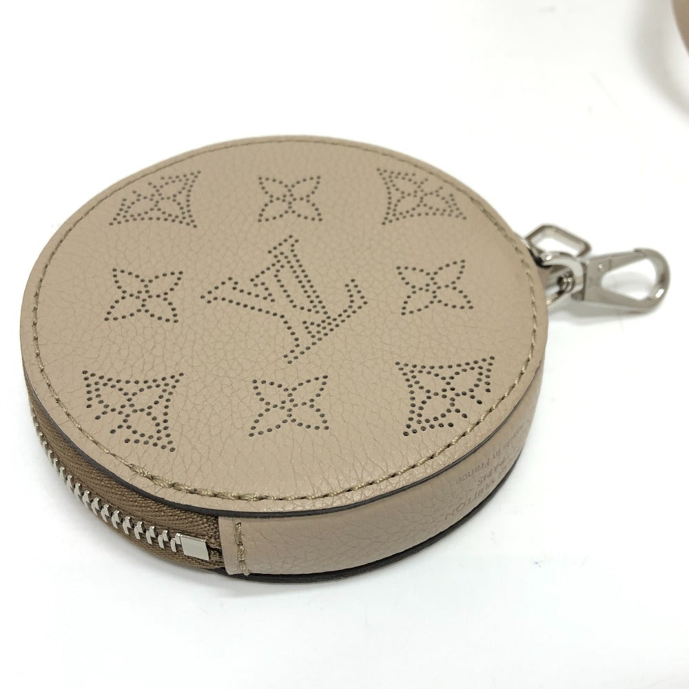 Round beige leather pouch with star pattern and metal zipper on a white background