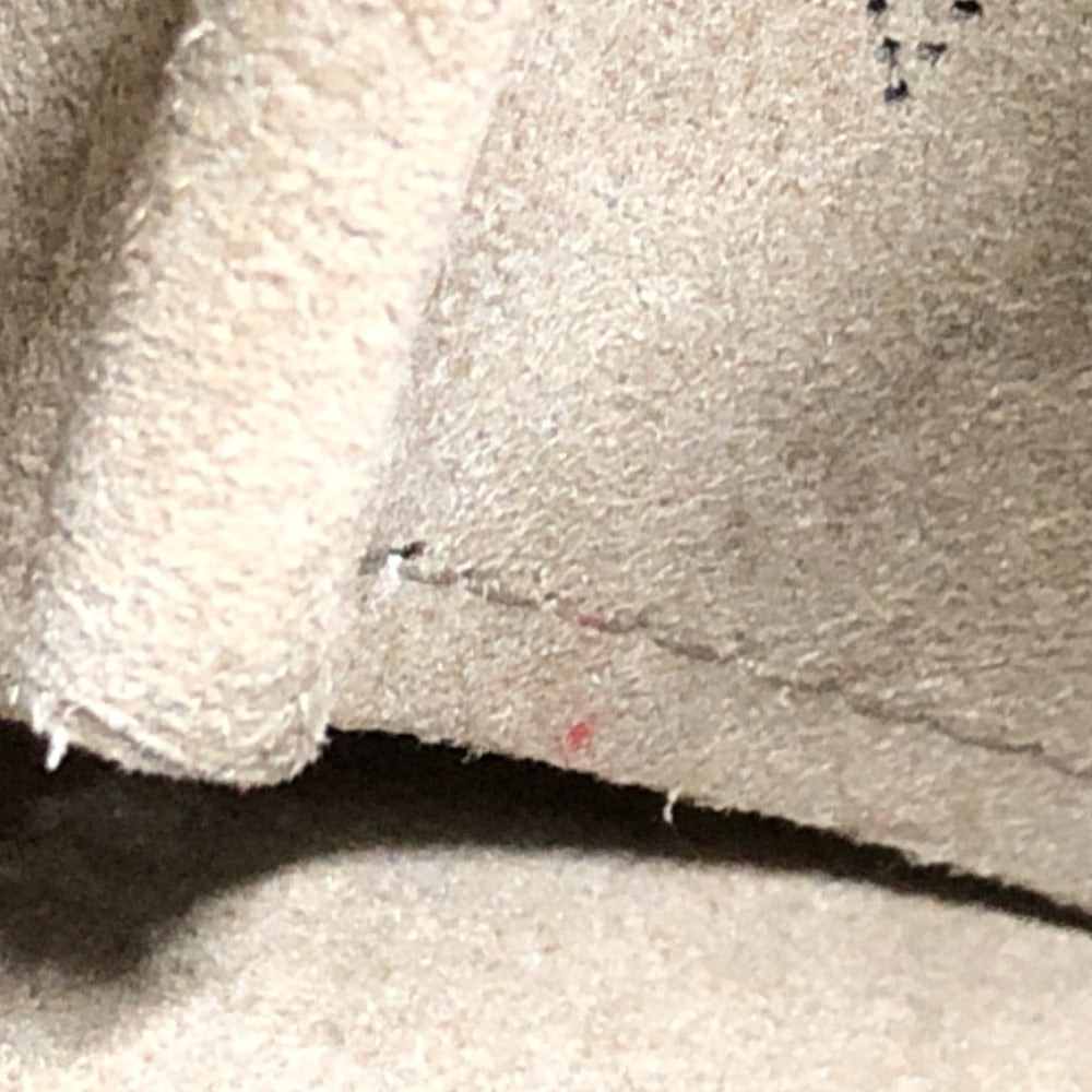 Close-up of textured beige fabric with visible stitching