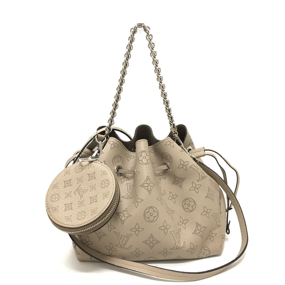 Beige handbag with monogram pattern and matching round pouch on a white background