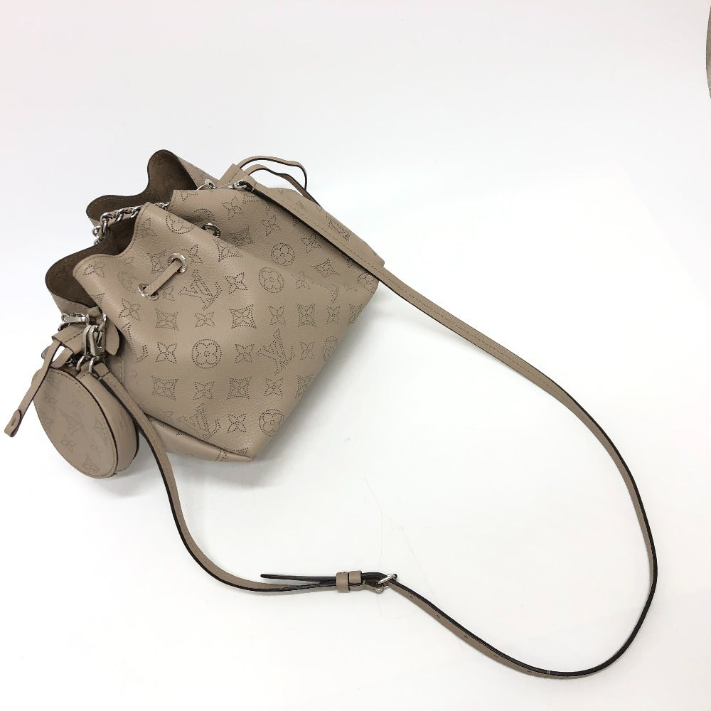 Beige handbag with monogram pattern on a white background