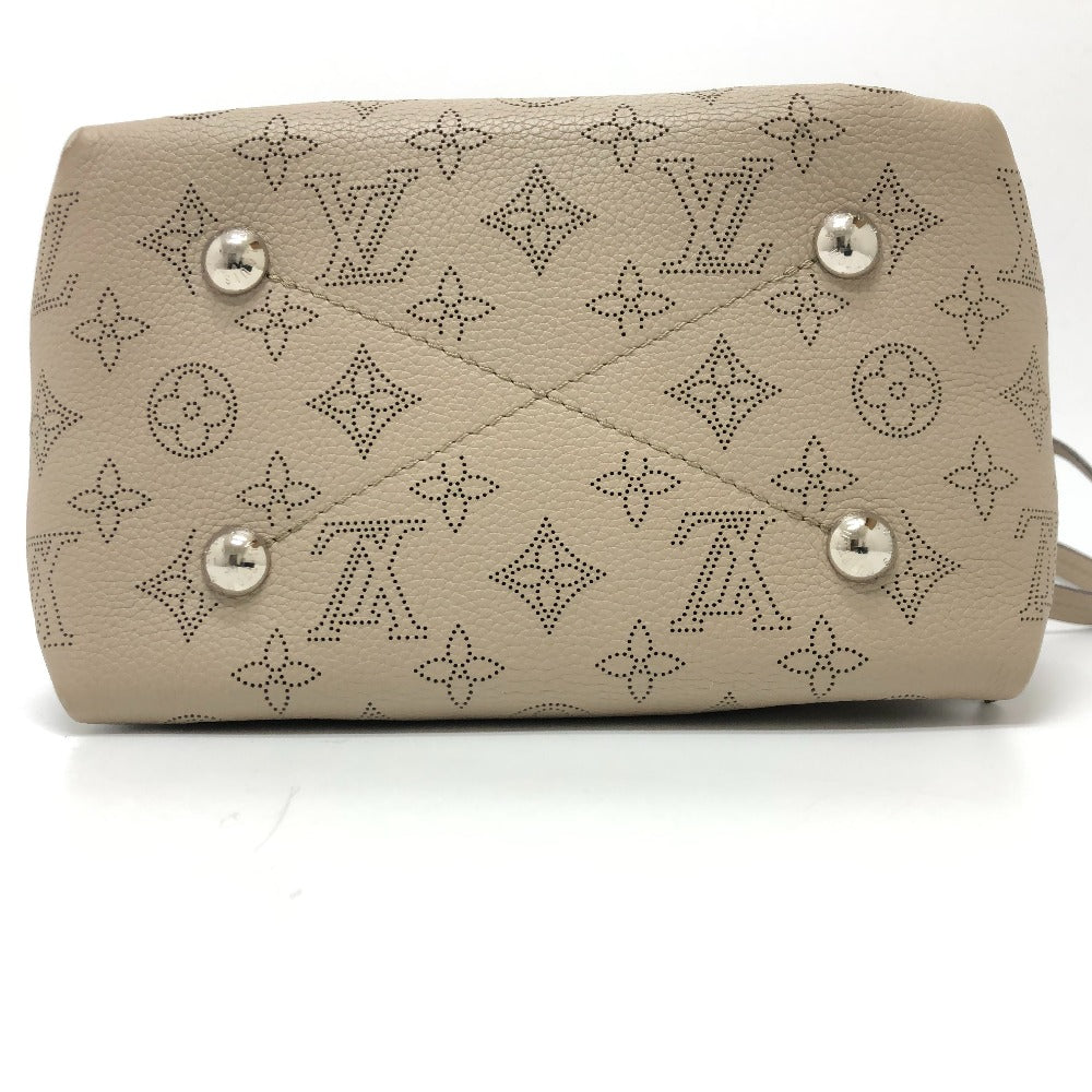 Beige handbag with brand logo pattern on a white background