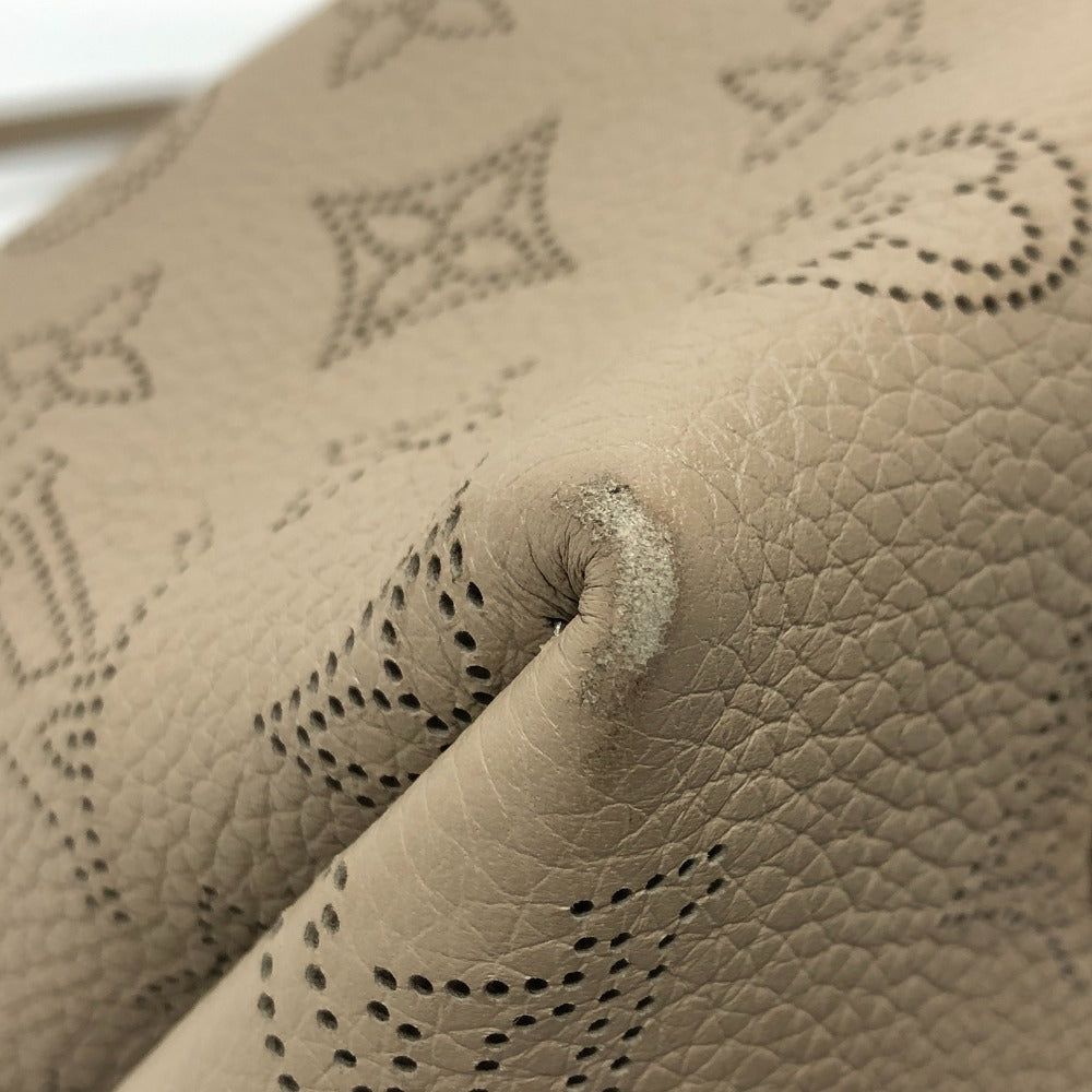 Close-up of beige leather with brand logo embossing