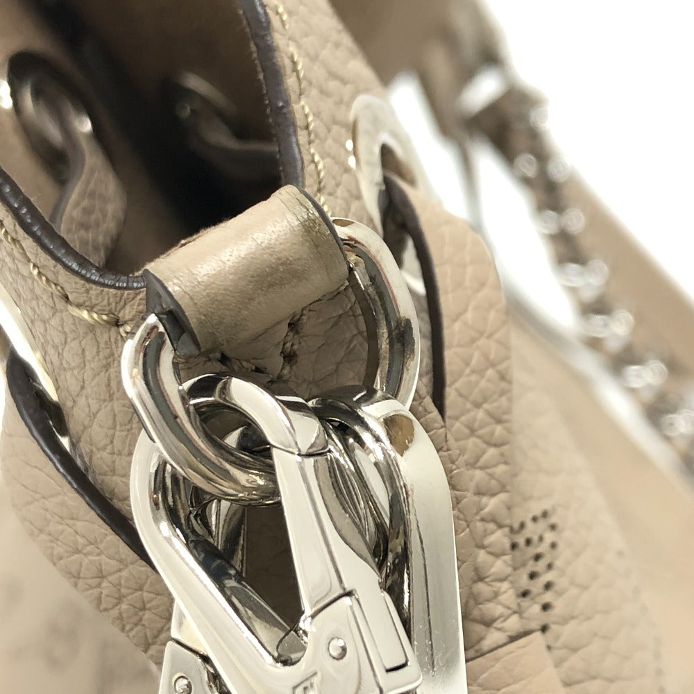 Close-up of a beige leather handbag with a silver clasp.