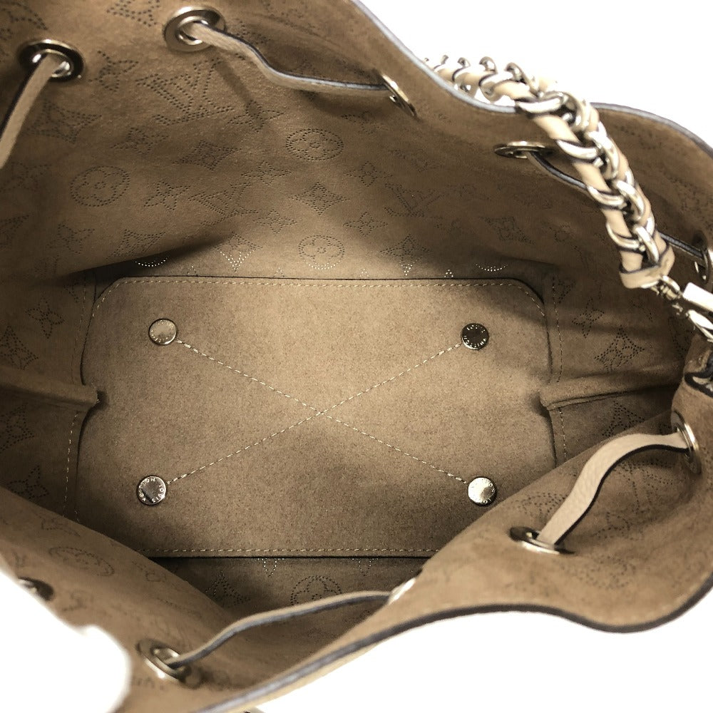Close-up of a brown leather handbag with visible branding and stitching details.