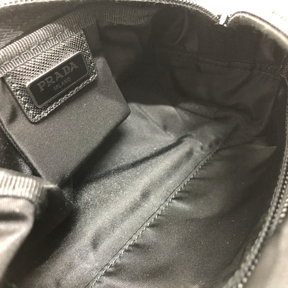 Close-up of a Prada bag with a visible logo on the interior.