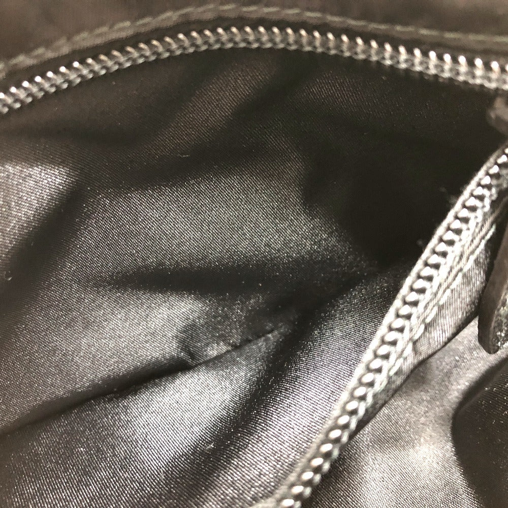 Close-up of a black leather bag with a silver chain detail.