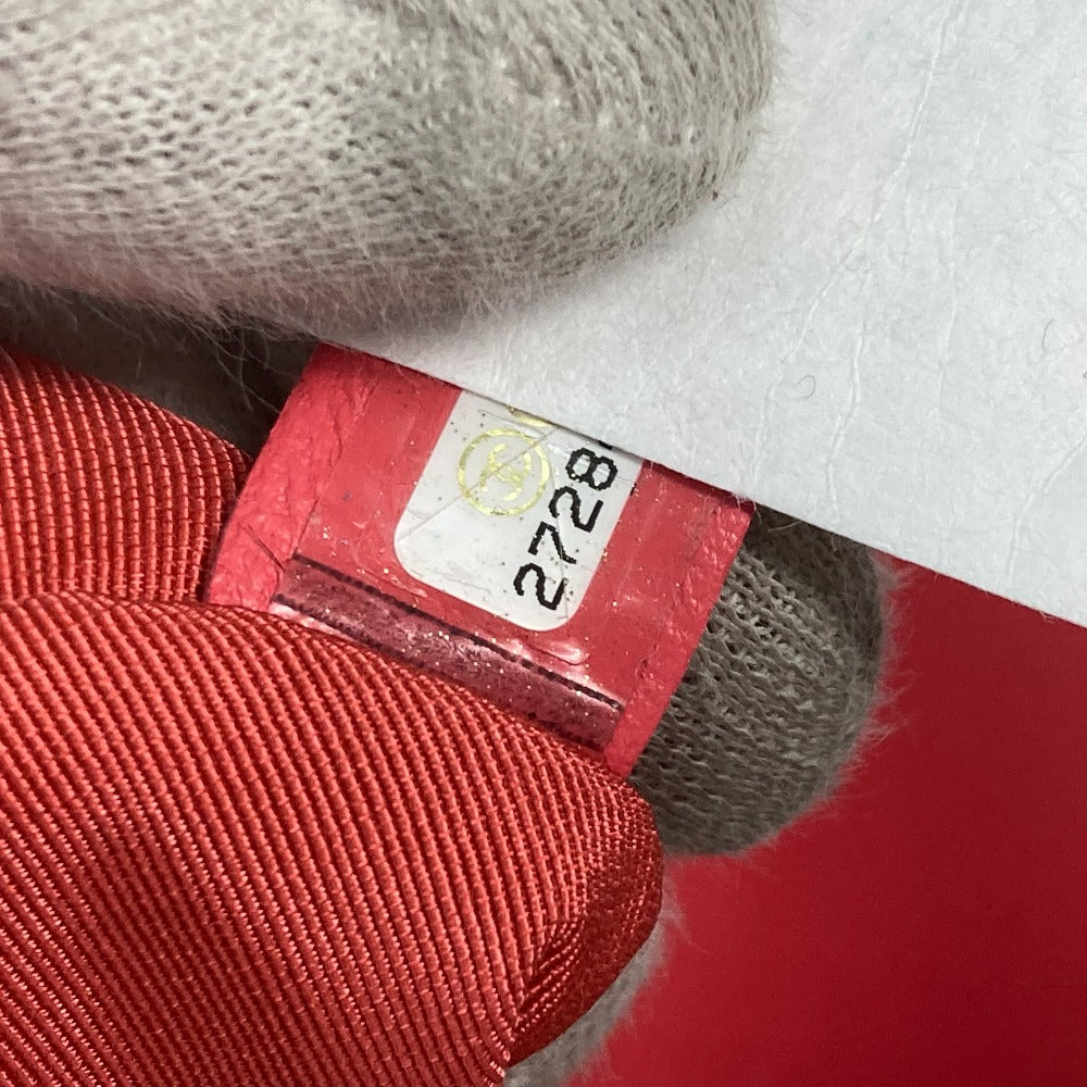 Close-up of a red tag with a number on a textured surface