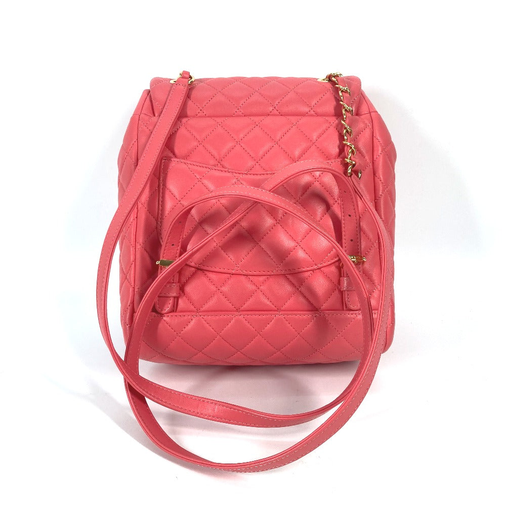 Pink quilted backpack with a gold zipper on a white background