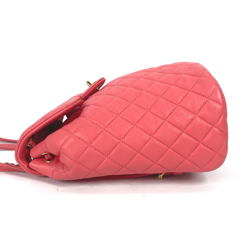 Pink quilted handbag on a white background