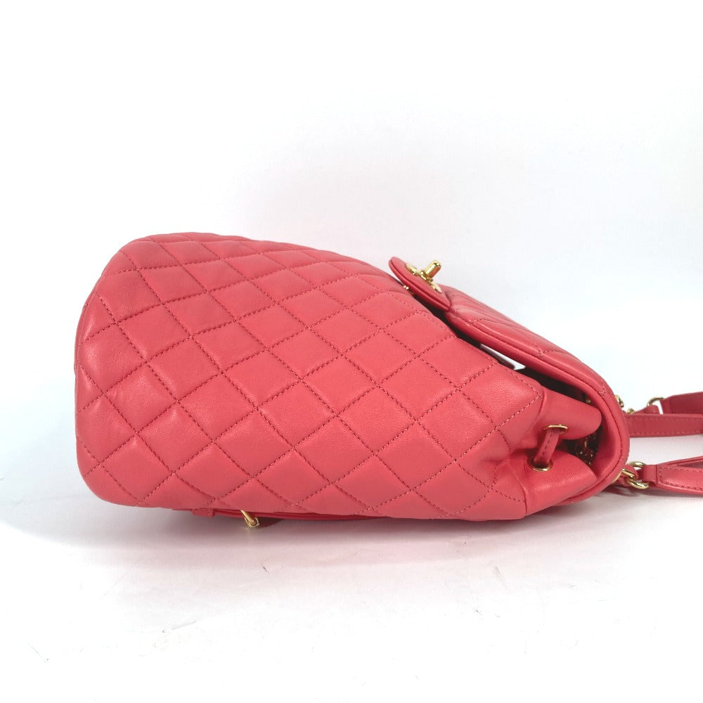 Pink quilted handbag on a white background