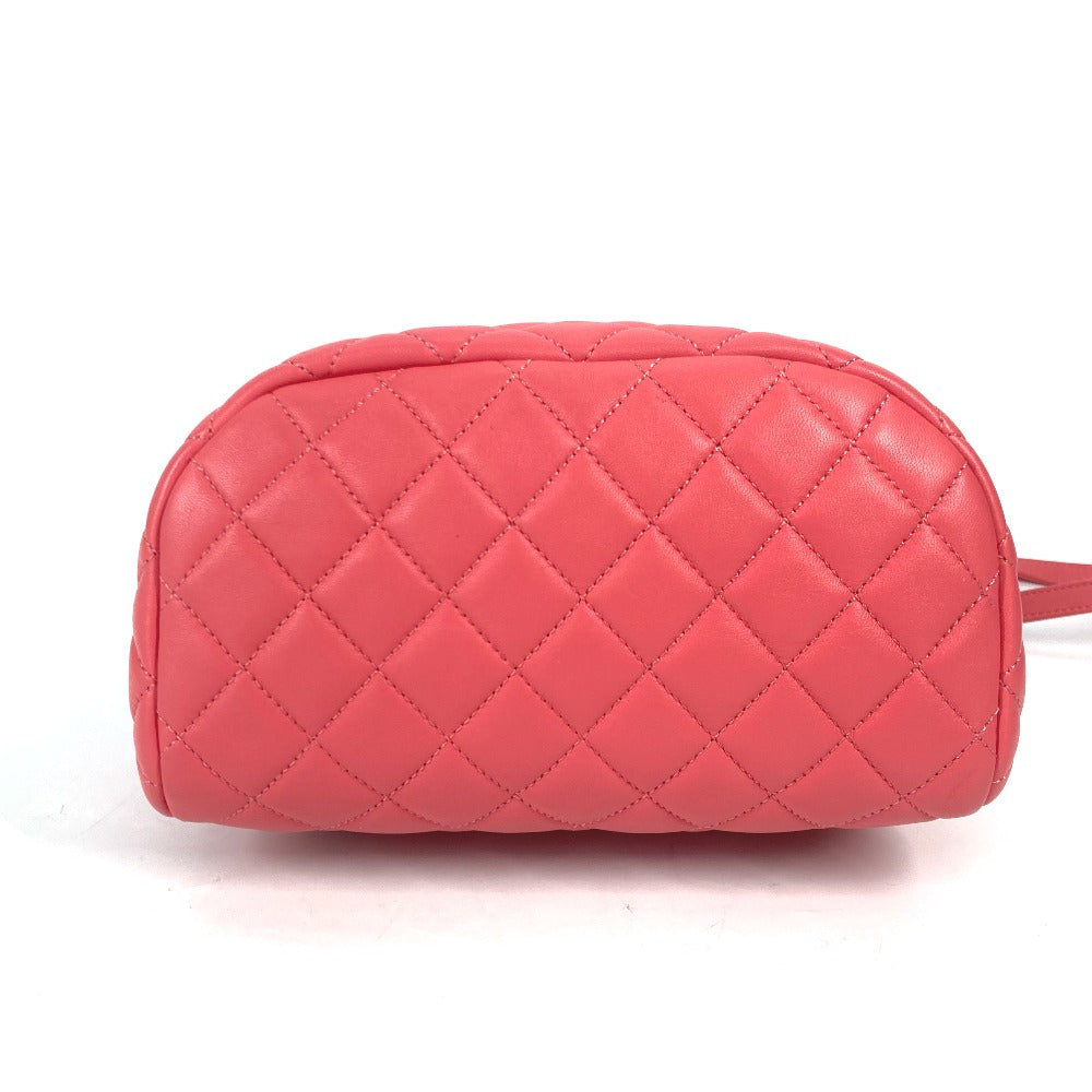 Pink quilted handbag on a white background