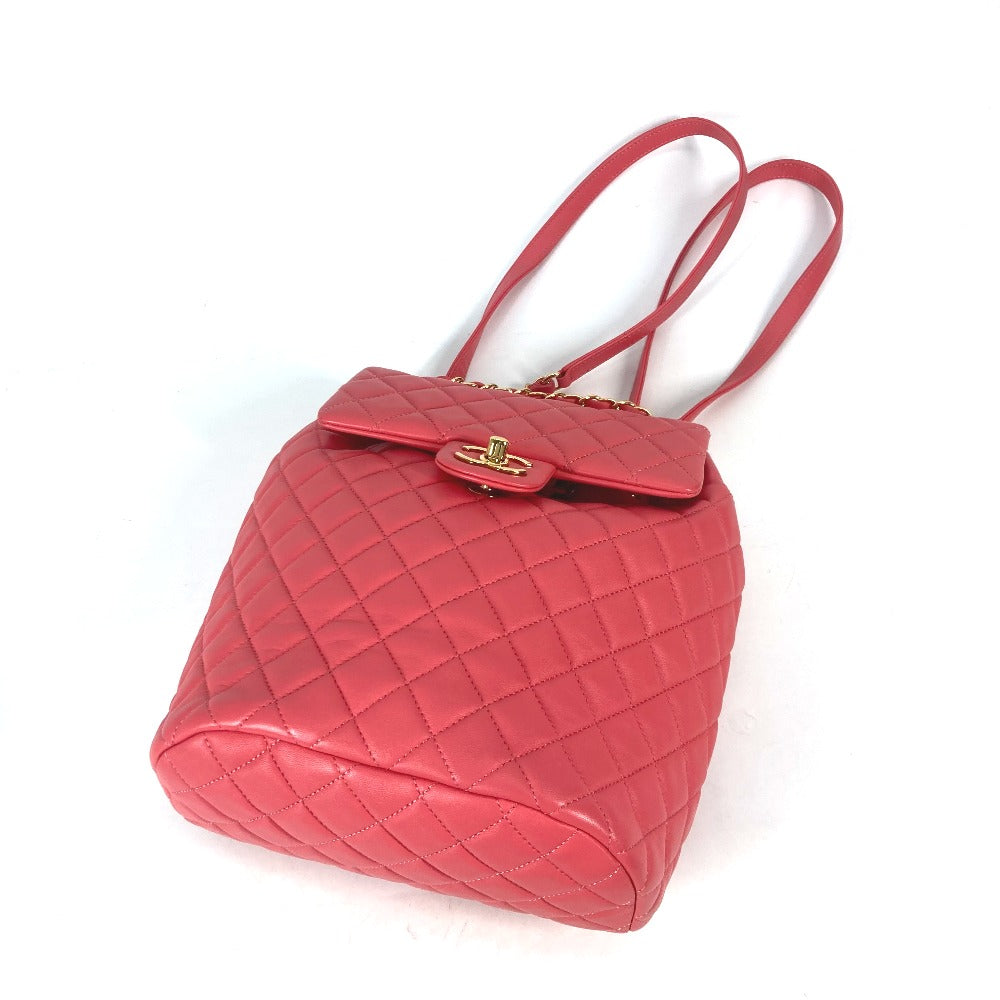 Red quilted handbag with a gold clasp on a white background