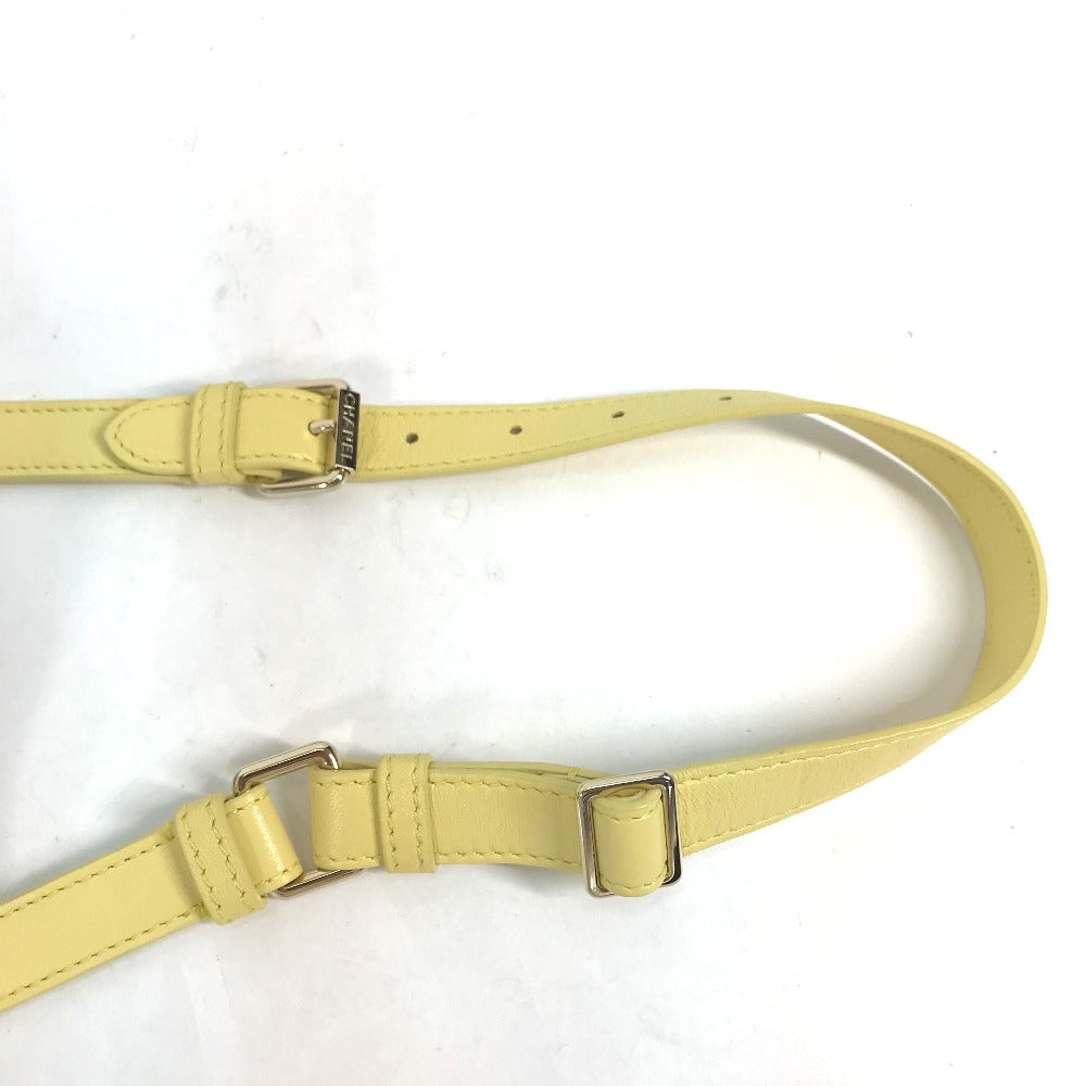 Yellow belt with a metal buckle on a white background