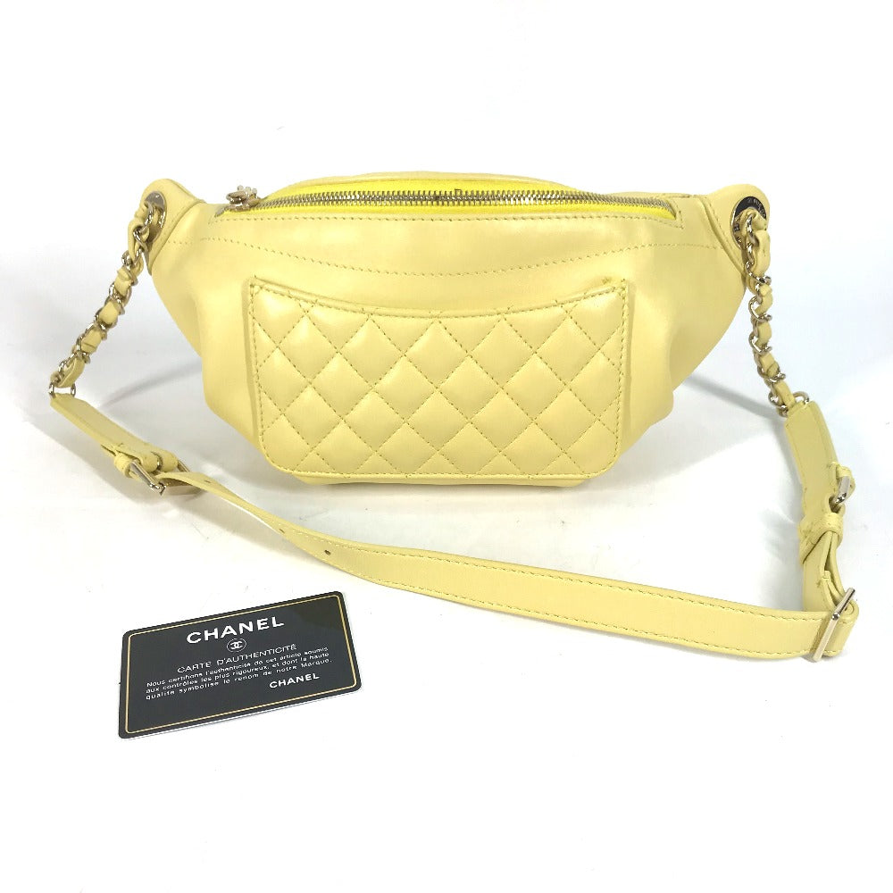 Yellow quilted handbag with Chanel tag on a white background
