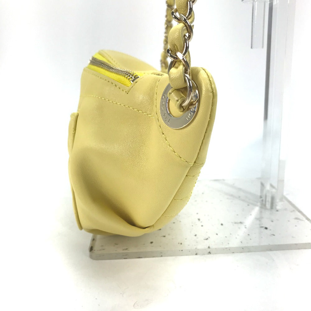 Yellow handbag with a chain strap on a white background