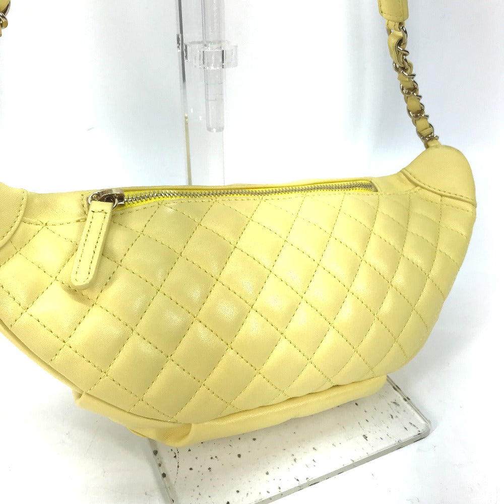 Yellow quilted handbag on a white background
