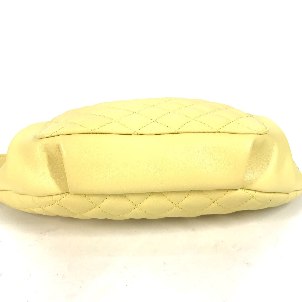 Yellow quilted handbag on a white background