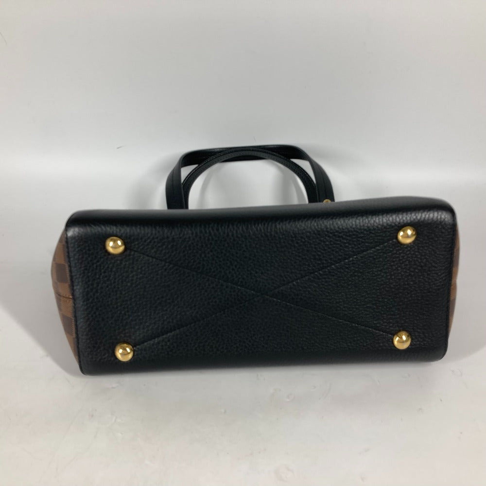 Black handbag with gold studs on a white background