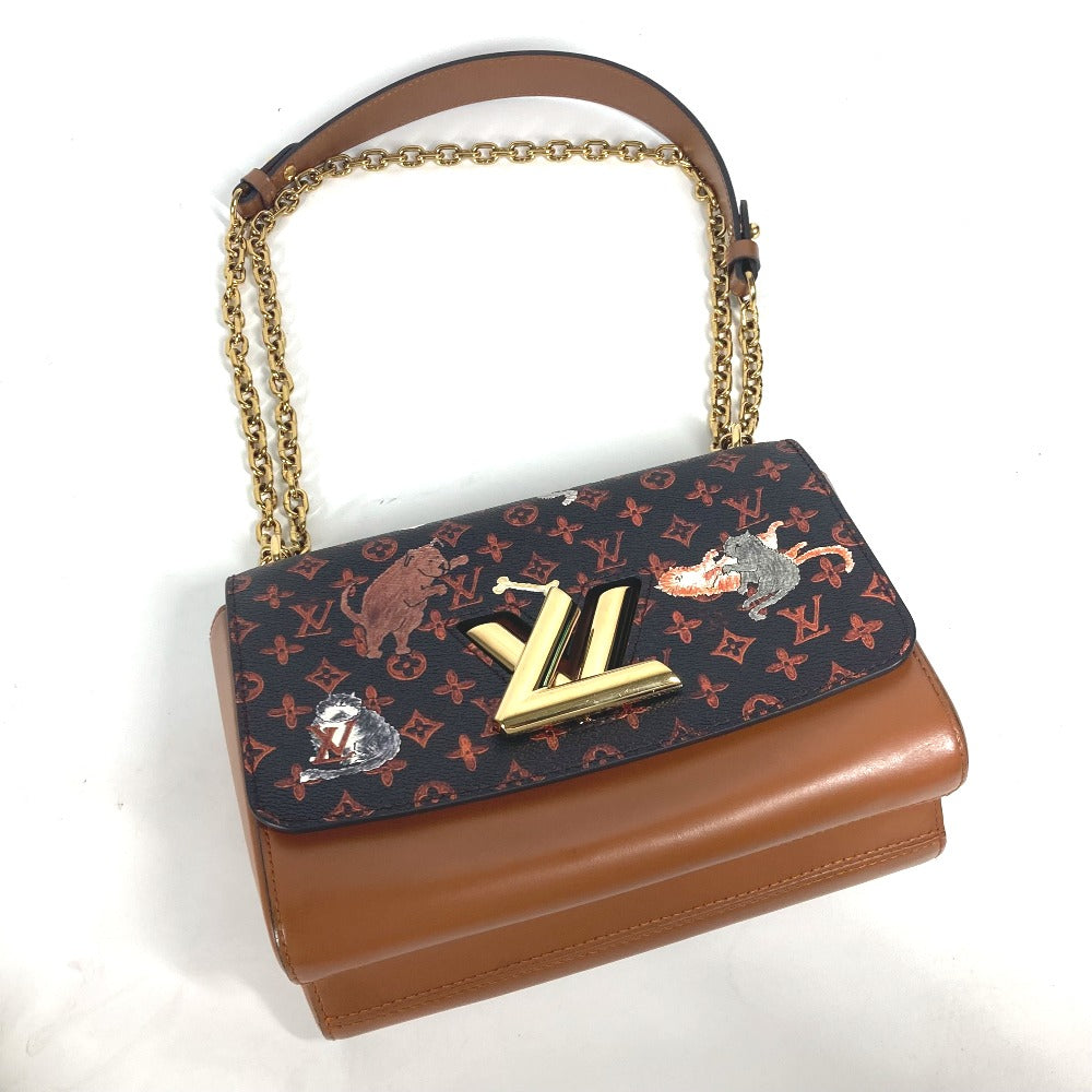 Designer handbag with brown leather bottom and gold chain handle on a white background