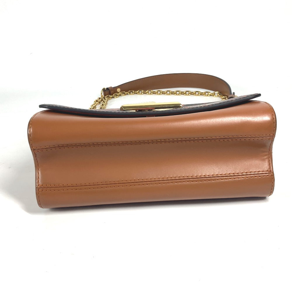Brown leather handbag with a gold chain handle on a white background