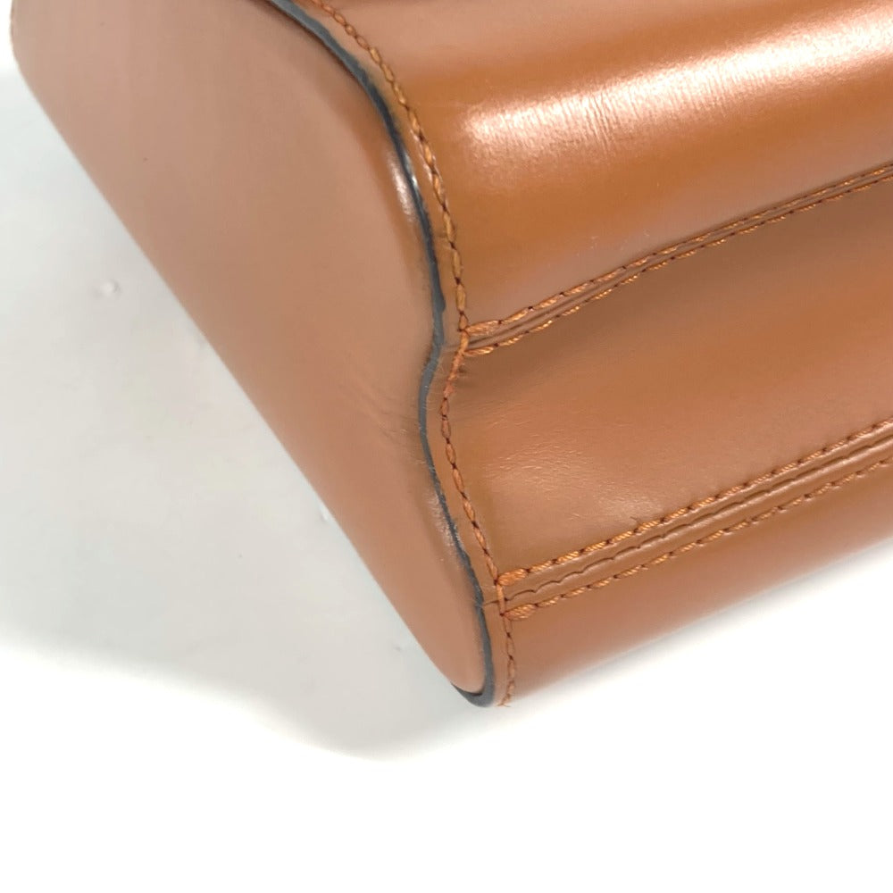Close-up of a brown leather product with visible stitching on a white background