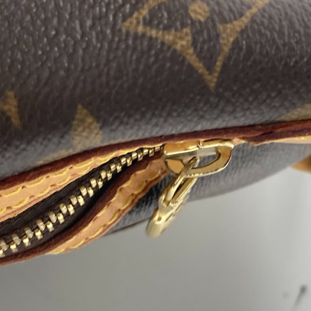 Close-up of a Louis Vuitton wallet with gold zipper and logo.