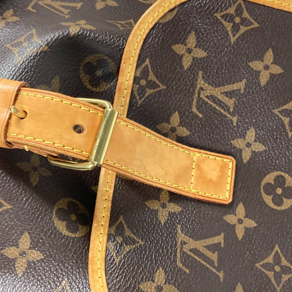 Close-up of a Louis Vuitton bag with monogram pattern and brown leather strap.