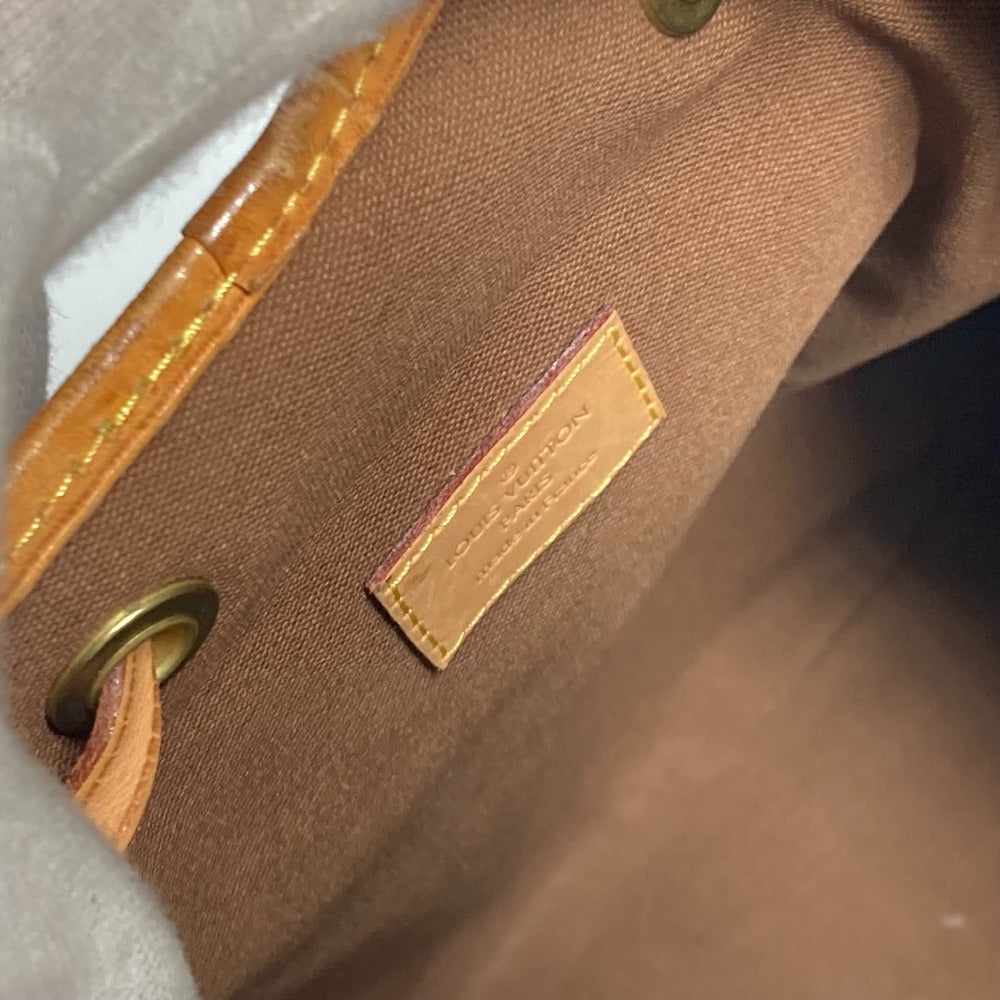Close-up of a brown leather bag with a visible brand label.