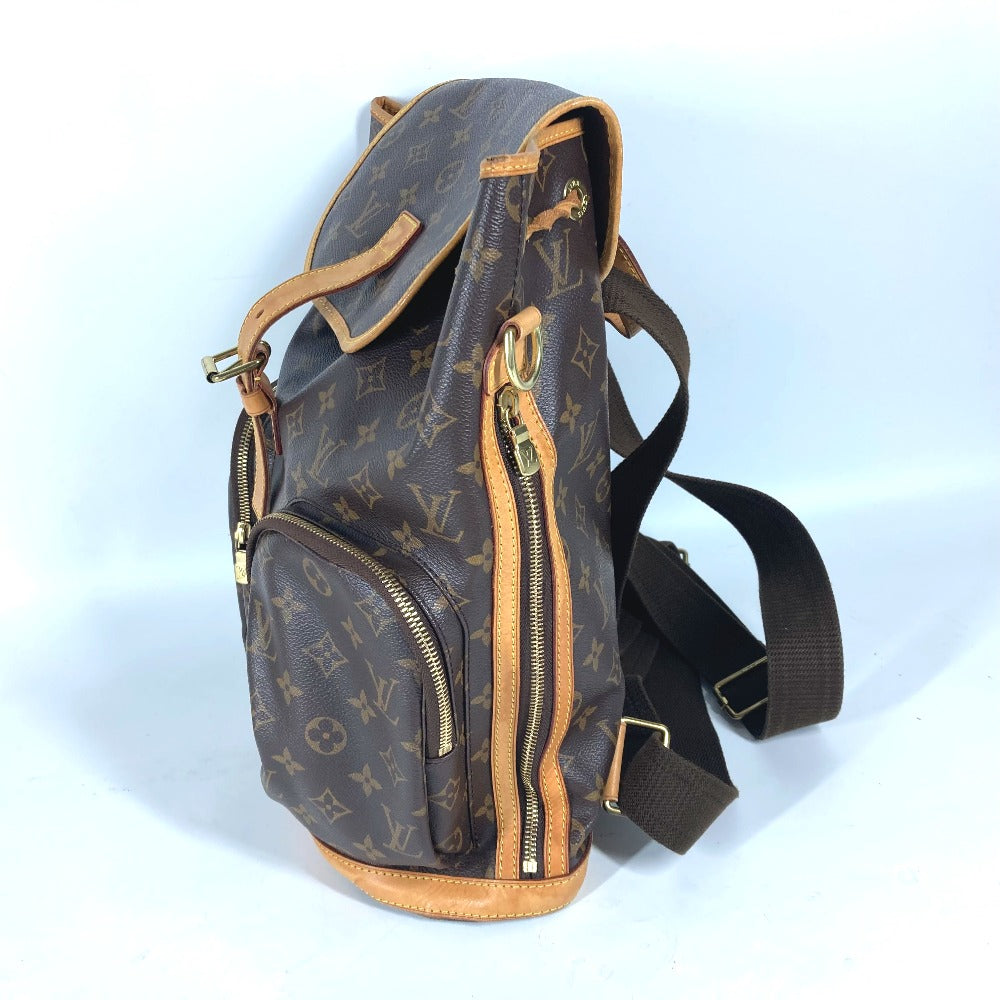 Brown monogram backpack with gold zippers on a light blue background