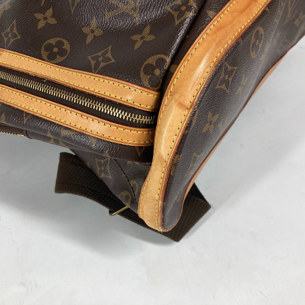Close-up of a brown leather bag with gold zipper on a white background