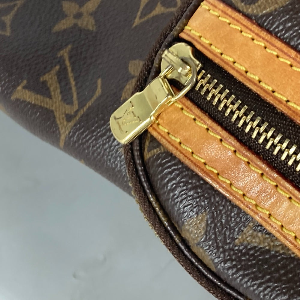 Close-up of a Louis Vuitton wallet with gold zipper and monogram pattern.